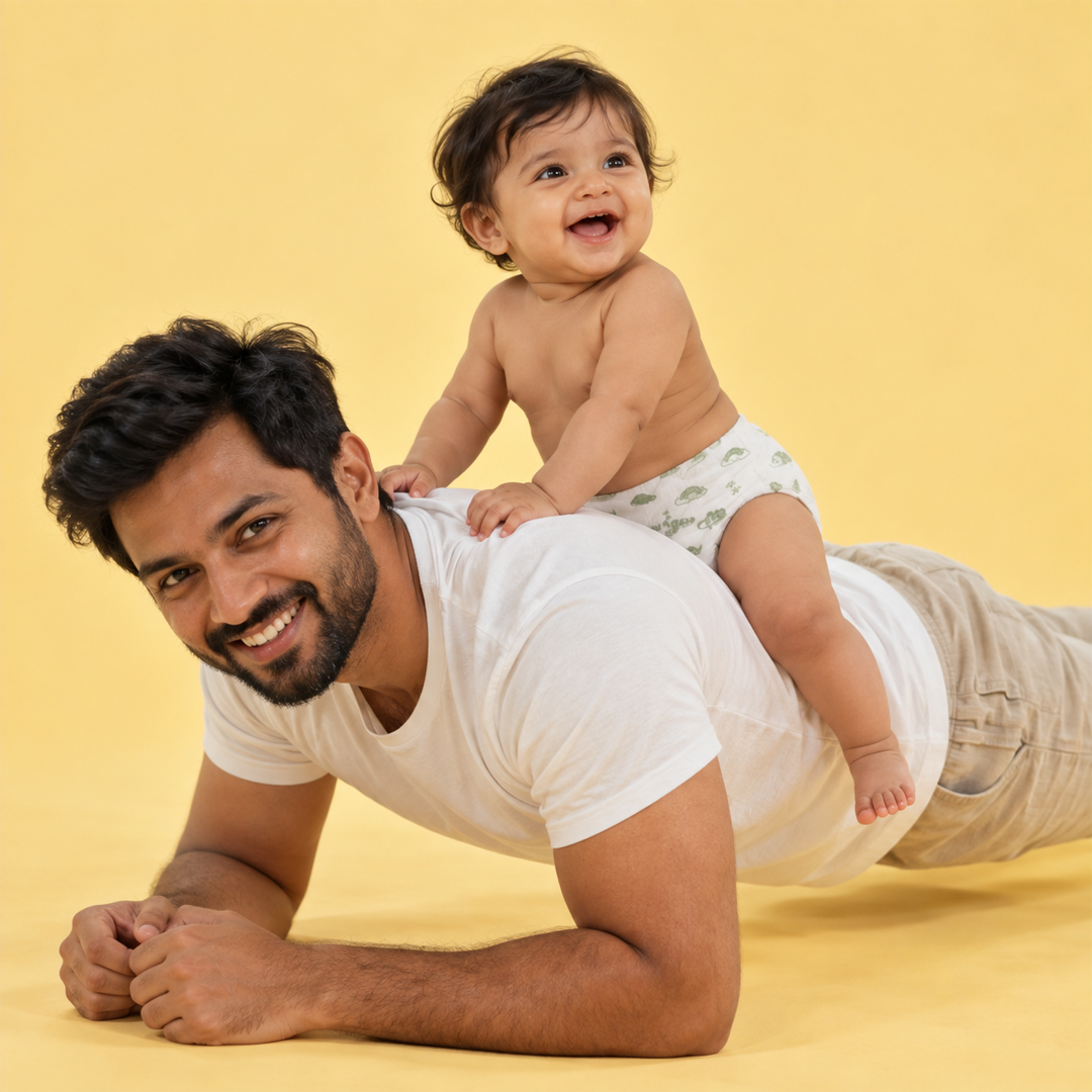 Baby riding piggyback on father's shoulders, wearing a Lumi9 diaper
